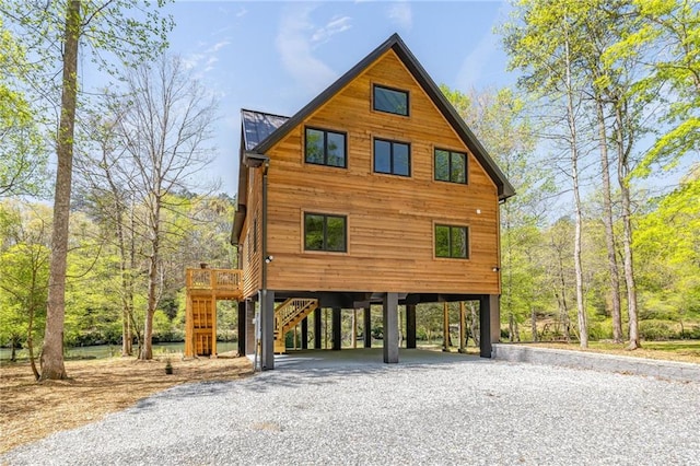 275 River Cliff Dr, Cornelia, GA 30531 - view of side of home with metal roof, driveway, a carport, and stairway