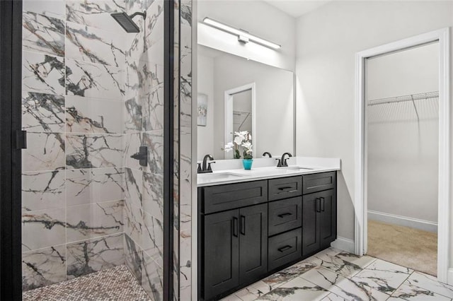 bathroom featuring a tile shower and vanity