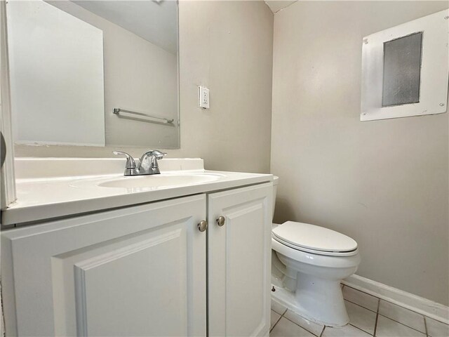 bathroom featuring vanity, toilet, and tile patterned flooring