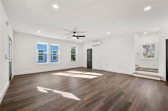 unfurnished living room with ceiling fan, dark hardwood / wood-style floors, and an AC wall unit