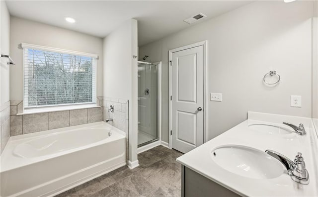 bathroom featuring vanity, shower with separate bathtub, and tile patterned floors