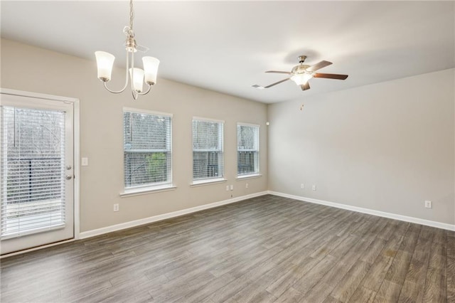 unfurnished room with dark hardwood / wood-style flooring and ceiling fan with notable chandelier