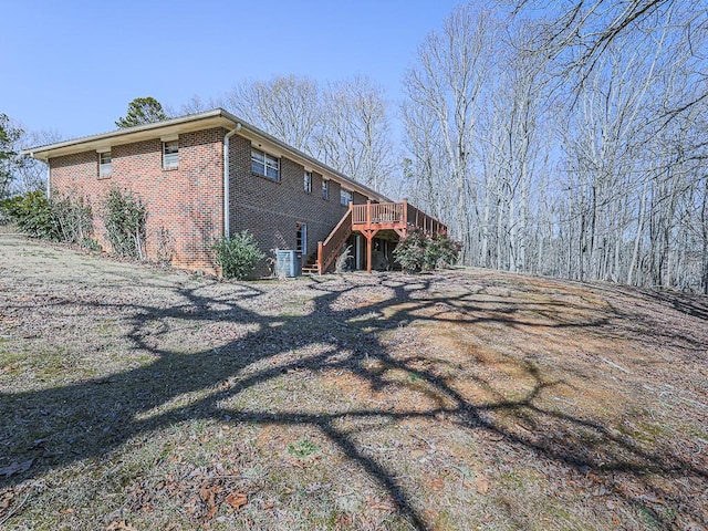 view of home's exterior featuring a deck and central AC