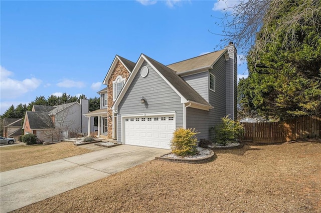 traditional-style home featuring driveway, a garage, a chimney, fence, and a front yard