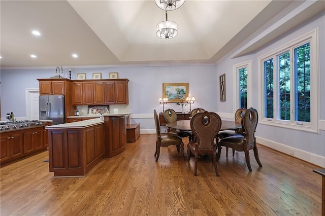 interior space featuring light hardwood / wood-style flooring, a wealth of natural light, and an inviting chandelier