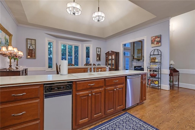 kitchen featuring light hardwood / wood-style floors, a notable chandelier, dishwasher, and sink