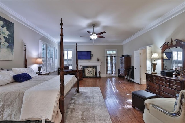 bedroom featuring dark hardwood / wood-style flooring, ceiling fan, and ornamental molding