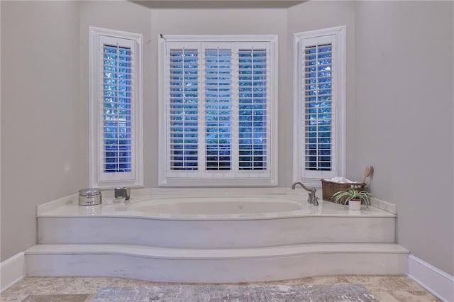 bathroom with tile floors and a bath