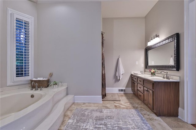 bathroom featuring tile flooring, dual vanity, and a tub