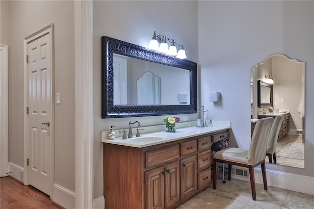 bathroom featuring dual vanity and wood-type flooring