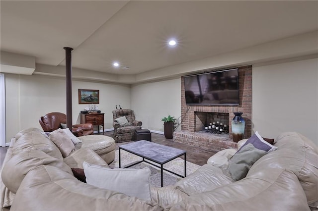 living room with brick wall and a fireplace