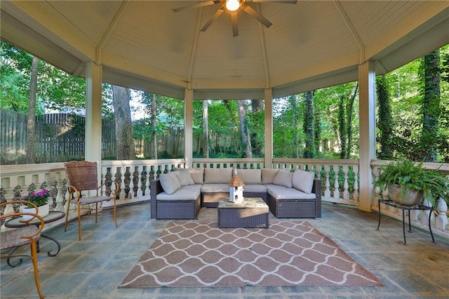 sunroom / solarium with lofted ceiling and ceiling fan