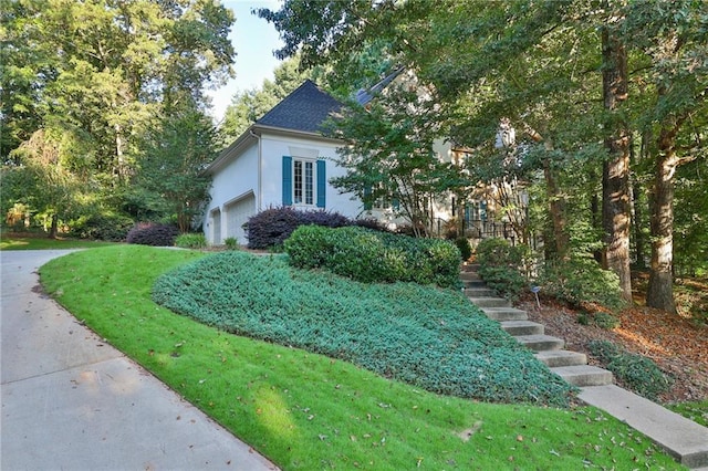 view of front of home with a front yard and a garage