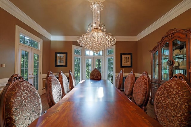 dining room with french doors, hardwood / wood-style floors, a chandelier, and a wealth of natural light