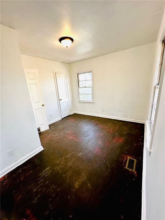 empty room featuring visible vents and baseboards