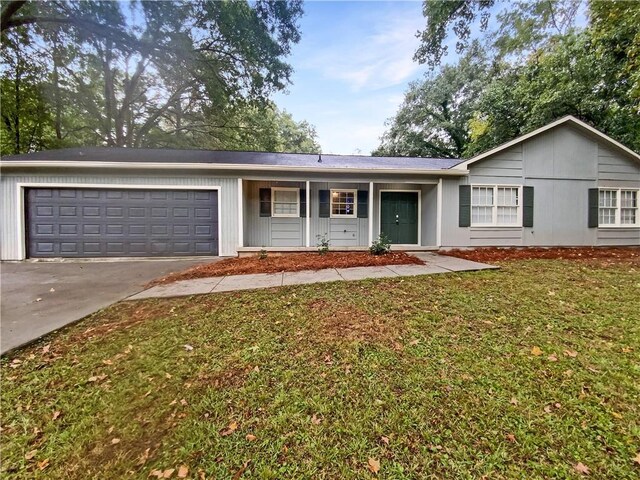 ranch-style home with a front lawn and a garage