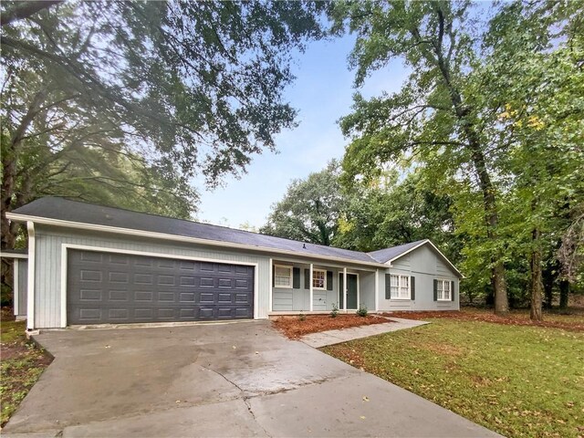 single story home with a front lawn and a garage