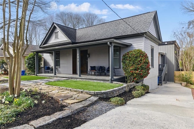 view of front of house with a shingled roof and covered porch