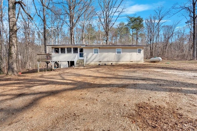 rear view of property with a wooden deck