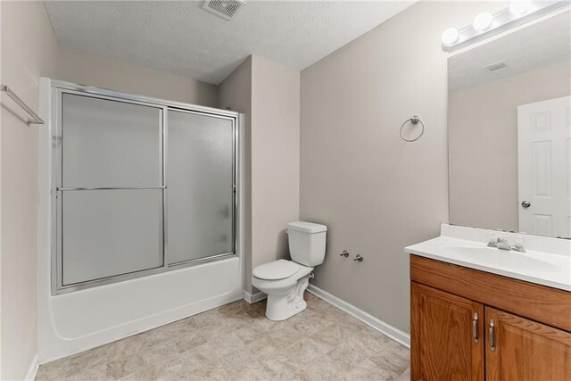 bathroom with vanity, toilet, enclosed tub / shower combo, baseboards, and visible vents