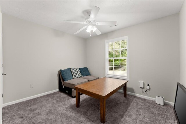 living area featuring baseboards, ceiling fan, carpet flooring, and visible vents