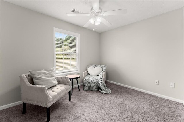 sitting room with baseboards, a ceiling fan, carpet flooring, and visible vents