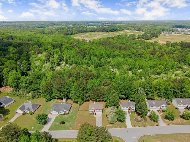 birds eye view of property with a wooded view