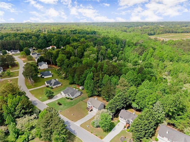 birds eye view of property featuring a view of trees and a residential view