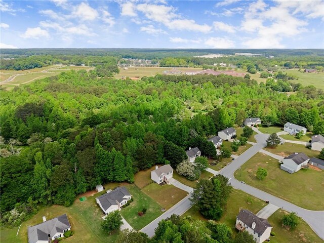 drone / aerial view featuring a view of trees