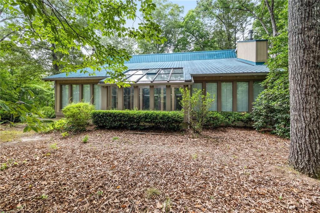 back of house featuring a sunroom