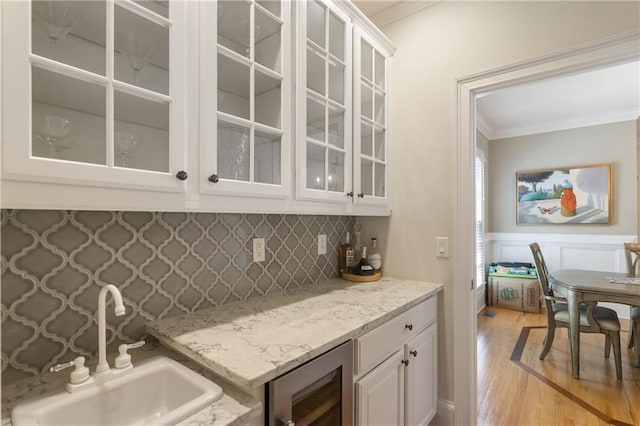 4404 Old Georgetown Trl, Atlanta, GA 30338 - indoor dry bar with wine cooler, ornamental molding, light wood-style flooring, backsplash, and wainscoting