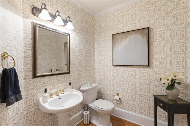 4404 Old Georgetown Trl, Atlanta, GA 30338 - half bathroom with crown molding, wallpapered walls, wood finished floors, toilet, and a sink