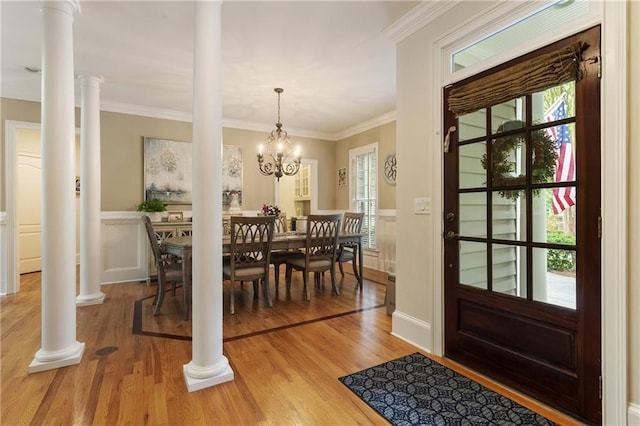 4404 Old Georgetown Trl, Atlanta, GA 30338 - foyer entrance featuring decorative columns, light wood finished floors, ornamental molding, and a wainscoted wall