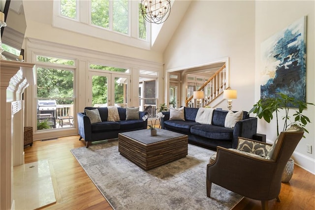 4404 Old Georgetown Trl, Atlanta, GA 30338 - living room with a high ceiling, stairway, wood finished floors, a chandelier, and french doors