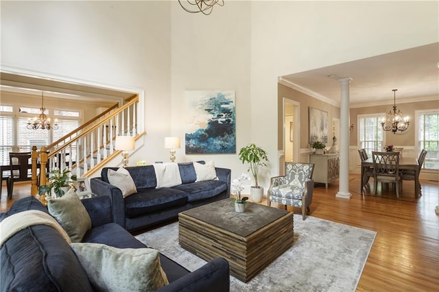 4404 Old Georgetown Trl, Atlanta, GA 30338 - living area with a chandelier, light wood finished floors, ornate columns, a towering ceiling, and ornamental molding