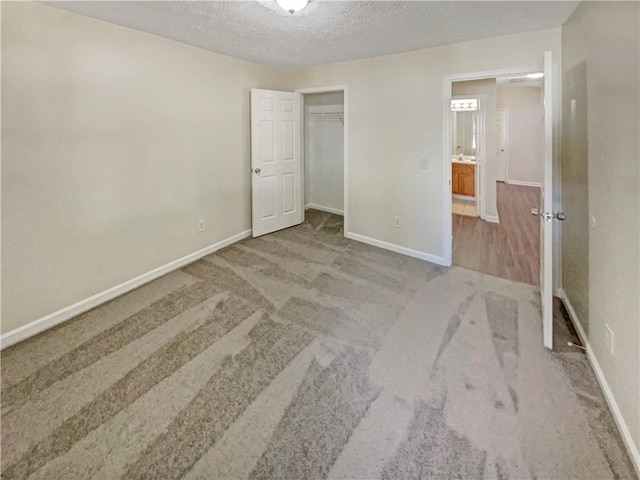 unfurnished bedroom with a closet, a textured ceiling, and carpet