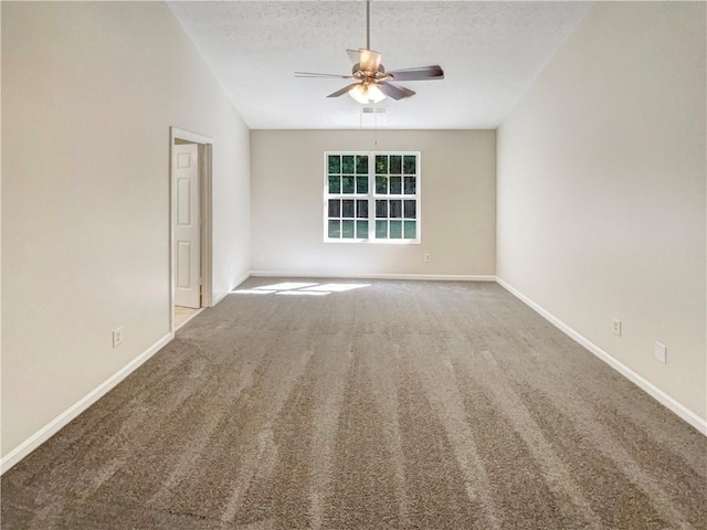 carpeted spare room with ceiling fan and a textured ceiling