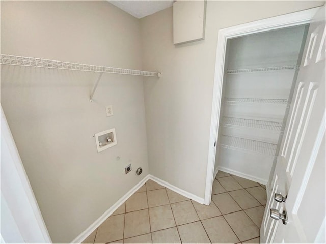 laundry area featuring light tile patterned floors, hookup for a washing machine, and hookup for an electric dryer