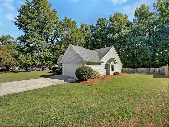 view of side of home with a yard and a garage