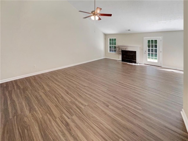 unfurnished living room featuring ceiling fan, dark hardwood / wood-style floors, and high vaulted ceiling