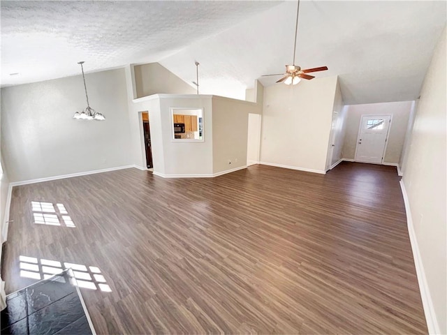 unfurnished living room with high vaulted ceiling, ceiling fan with notable chandelier, a textured ceiling, and dark hardwood / wood-style flooring