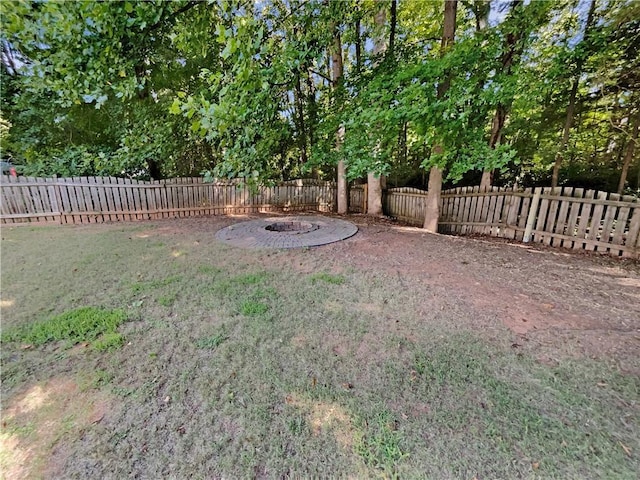 view of yard with an outdoor fire pit