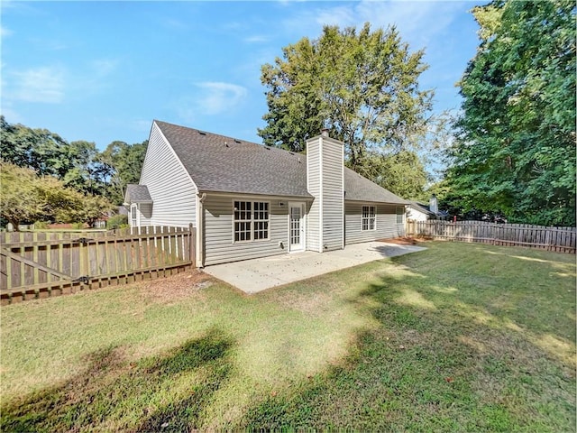 back of house featuring a yard and a patio area