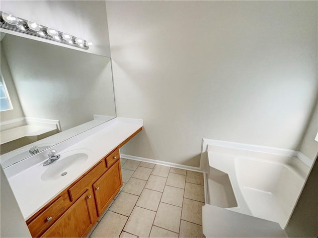 bathroom featuring vanity, tile patterned flooring, and a bathing tub