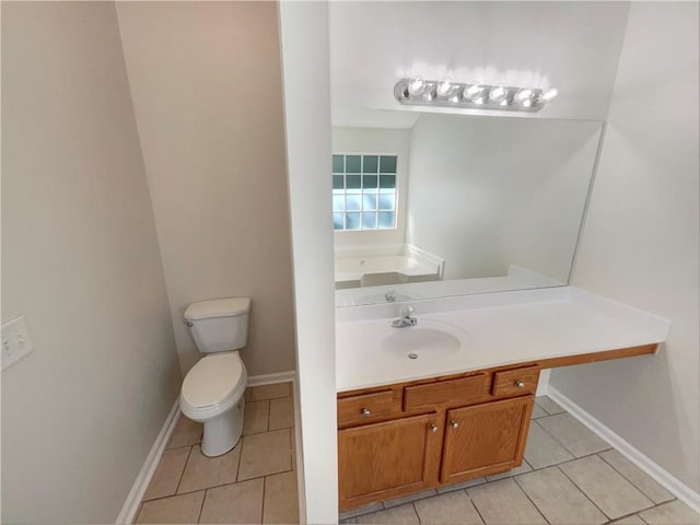 bathroom featuring vanity, tile patterned floors, and toilet