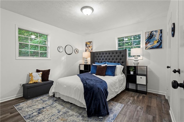 4781 Brownsville Rd, Powder Springs, GA 30127 - bedroom with wood finished floors, a textured ceiling, and baseboards