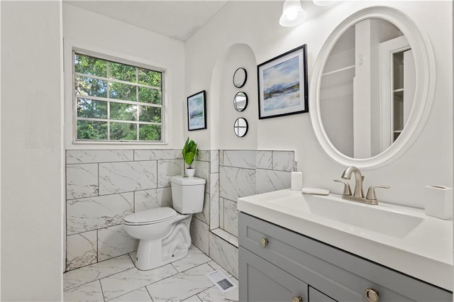 4781 Brownsville Rd, Powder Springs, GA 30127 - bathroom with marble finish flooring, tile walls, toilet, vanity, and a wainscoted wall
