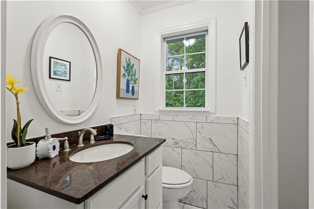 4781 Brownsville Rd, Powder Springs, GA 30127 - bathroom with tile walls, ornamental molding, toilet, vanity, and a wainscoted wall
