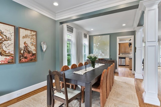 dining space featuring light wood-style floors, ornamental molding, and decorative columns