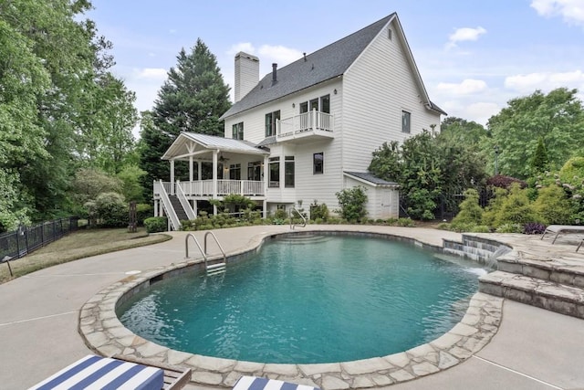 view of swimming pool featuring stairway, a patio, fence, and a fenced in pool